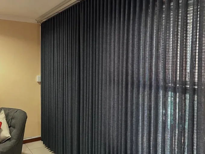 Charcoal vertical blinds fitted floor to ceiling in a Cape Town lounge