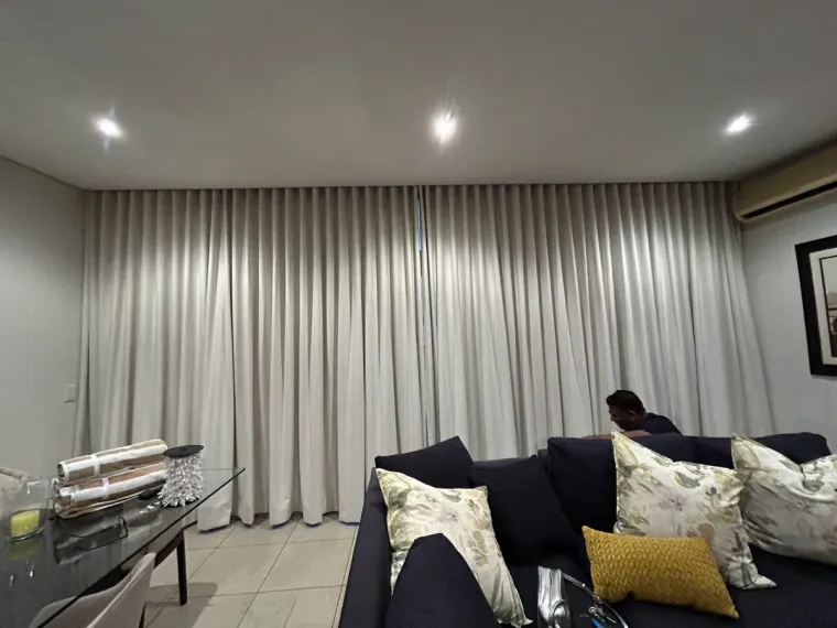 Cream wave curtains fitted floor to ceiling in a Cape Town lounge