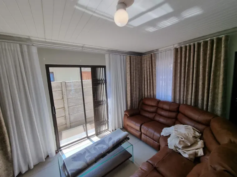 Brown patterned curtains with white sheers in a Cape Town lounge