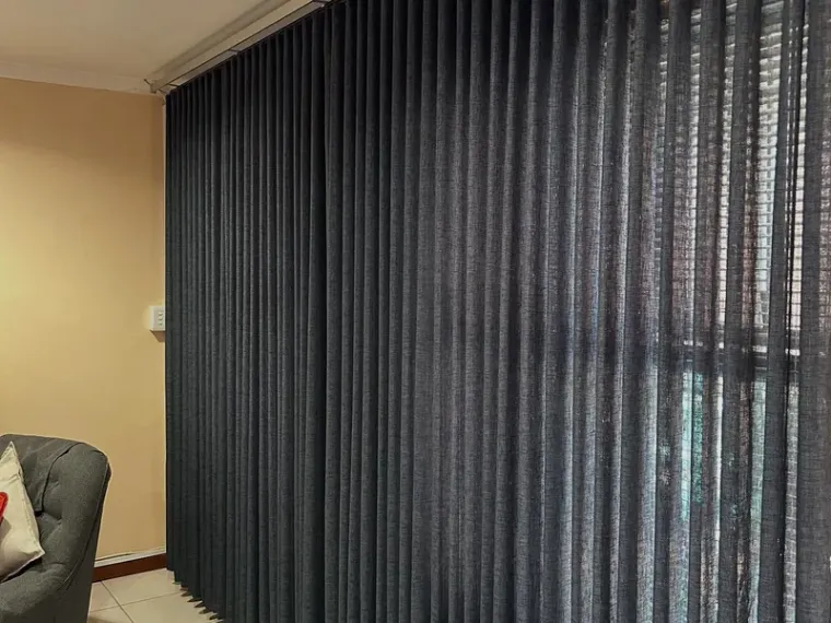 Charcoal vertical blinds fitted floor to ceiling in a Cape Town lounge