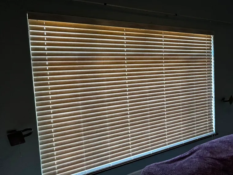 Wood-tone venetian blinds in a Cape Town bedroom