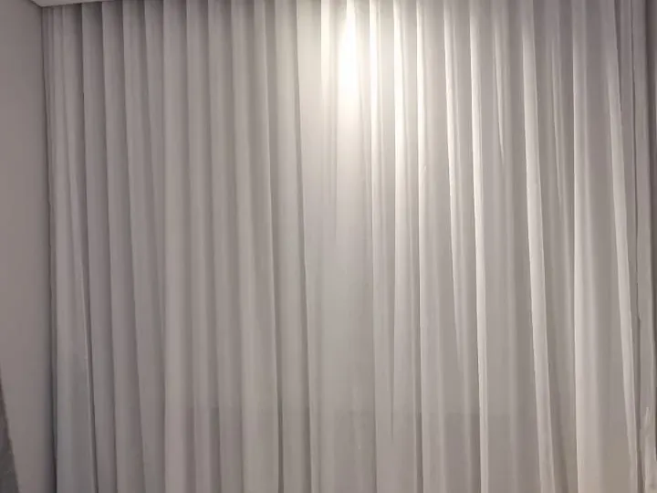 White wave sheer curtains wall to wall in a Strand bedroom, Cape Town