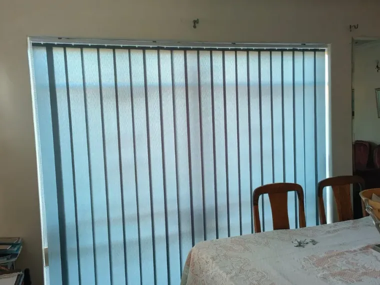 Light blue vertical blinds fitted on a sliding door in a Cape Town dining room